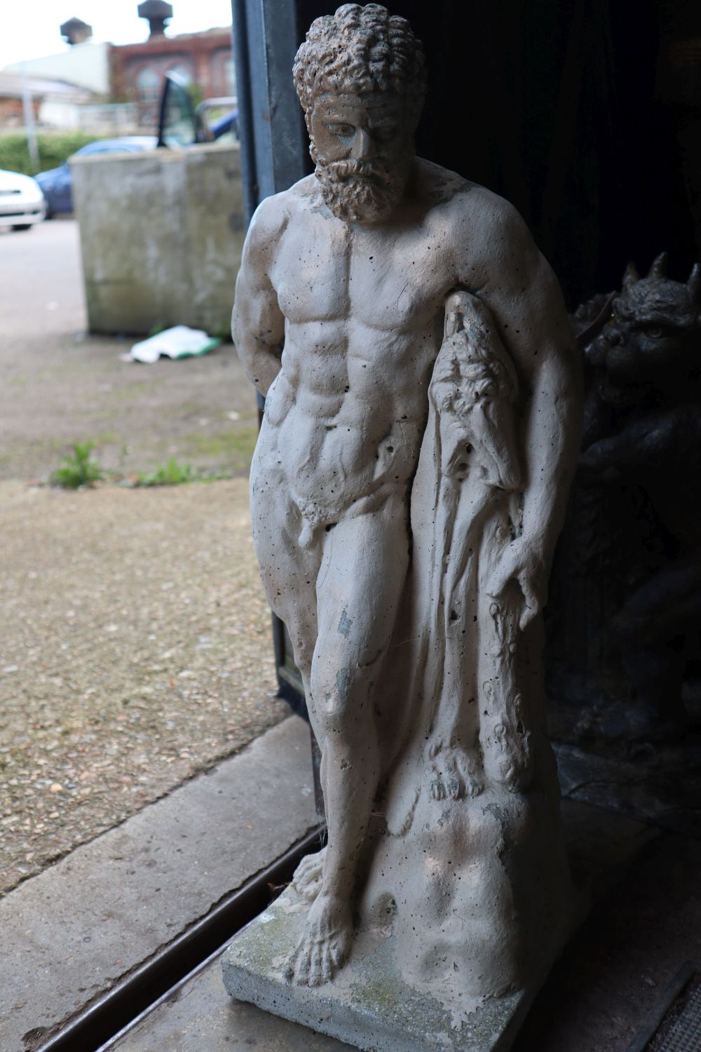 Three composition gargoyle garden ornaments and a reconstituted stone garden ornament, tallest 60cm